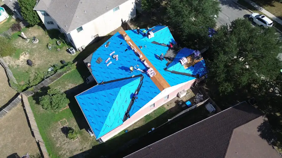 Hail-damaged roof being replaced with new underlayment