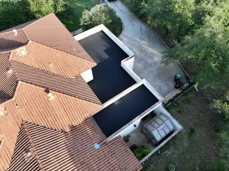 Tile and flat roof sections by DNA Restoration & Construction