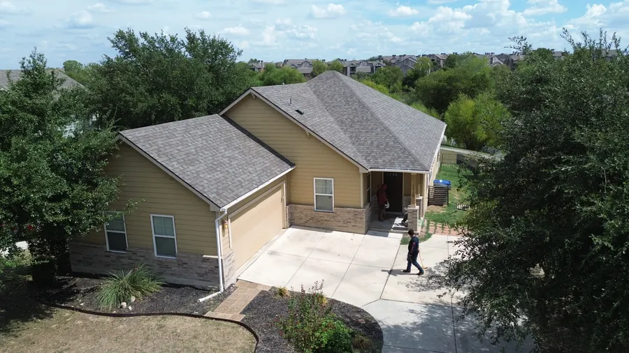 Finished roof on a two-story home in north San Antonio near Stone Oak by DNA Restoration & Construction